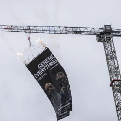 Banner dropped off CBD crane reveals international act