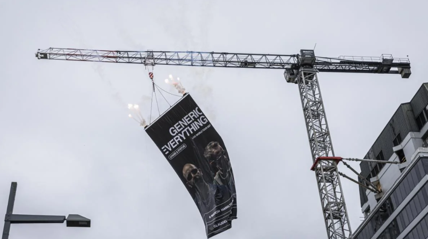 Banner dropped off CBD crane reveals international act